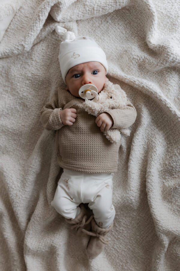 geboortepakje - geboorte pakje jongen - newborn kleding - newborn kleding jongen - babybroekje konijntjes - babybroekje konijn - overslagshirt beige - overslagshirt cable dark beige - merino wol slofjes zand - babyslofjes - babymutsje - babymutje konijn